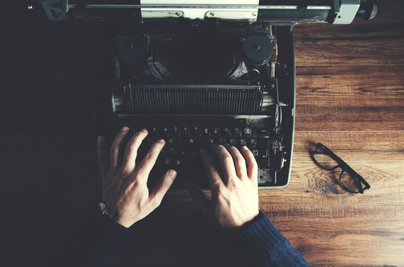 Typewriter with man hand on table